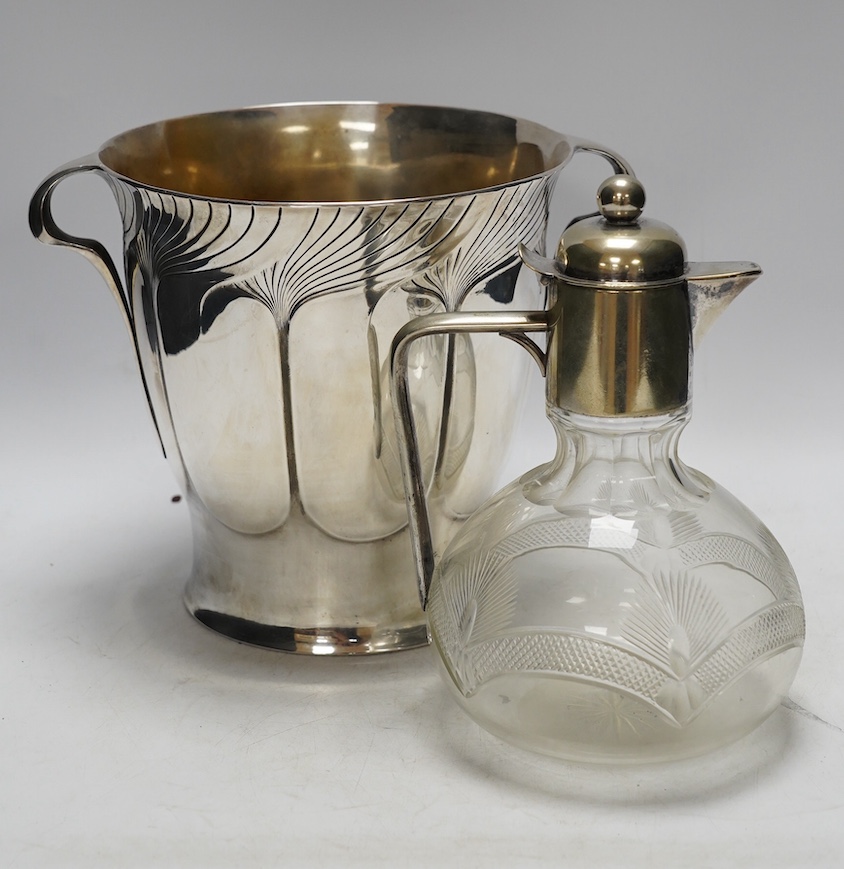 An Art Nouveau Orivit polished pewter wine cooler, c.1905, impressed model number 2447, 20cm high, and an early 20th century WMF electroplate mounted cut glass claret jug, 21.5cm high (2). Condition - fair to good